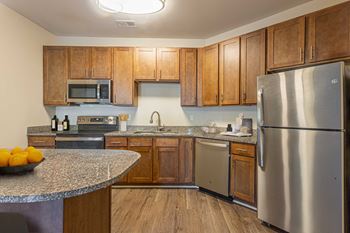 a kitchen with stainless steel appliances and granite counter tops at Two Addison Place, Georgia